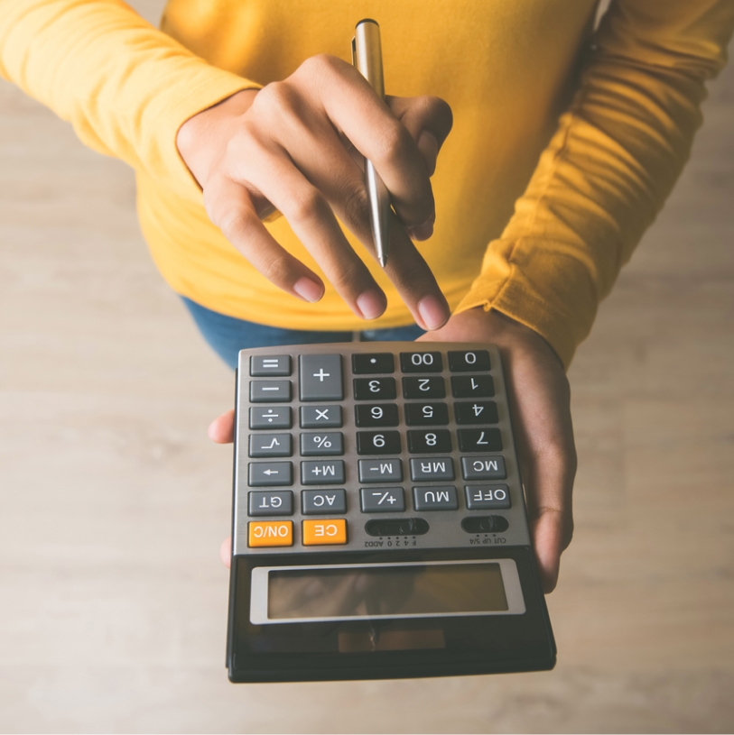 Mains d'une femme tapant sur une calculatrice